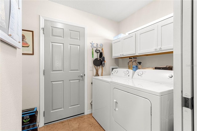 washroom with light tile patterned floors, cabinet space, and independent washer and dryer