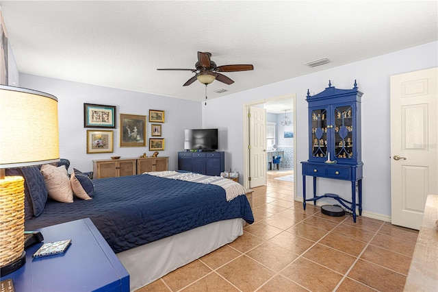 tiled bedroom with visible vents, baseboards, a textured ceiling, and ceiling fan