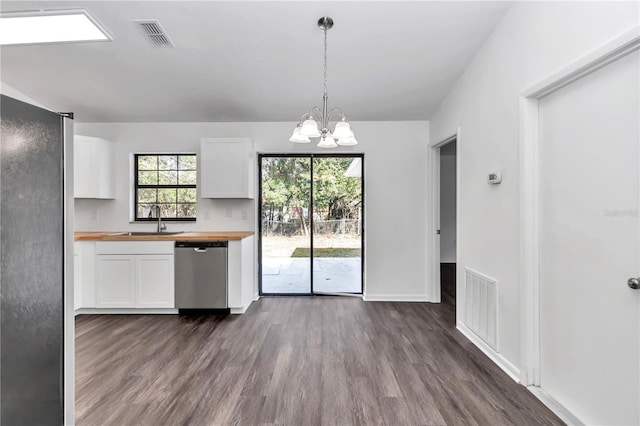 kitchen with appliances with stainless steel finishes, white cabinetry, hanging light fixtures, and sink