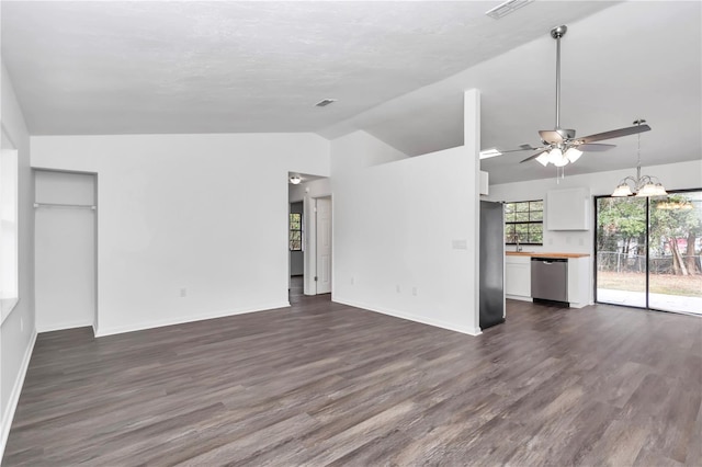 unfurnished living room with ceiling fan with notable chandelier, lofted ceiling, and dark wood-type flooring