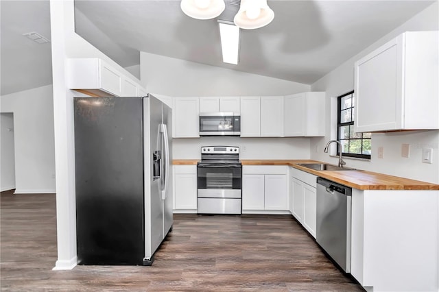 kitchen featuring butcher block counters, sink, white cabinets, and appliances with stainless steel finishes