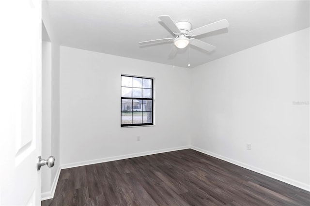 spare room featuring ceiling fan and dark wood-type flooring