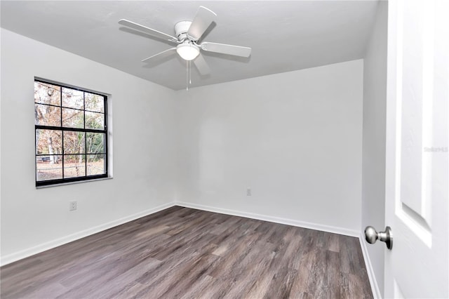 spare room with ceiling fan and dark wood-type flooring