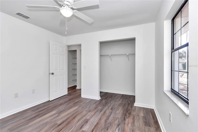 unfurnished bedroom featuring dark hardwood / wood-style flooring and ceiling fan