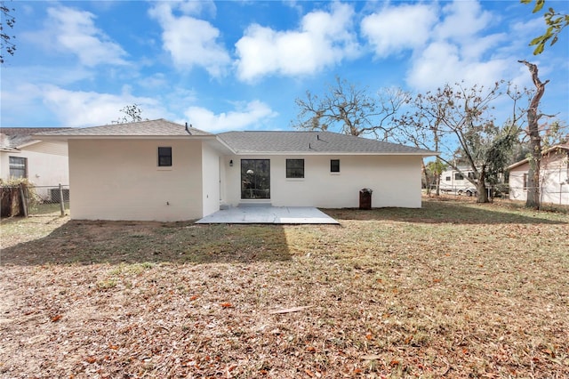 back of house with a lawn and a patio area