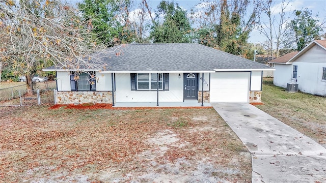 ranch-style home featuring cooling unit and a front lawn