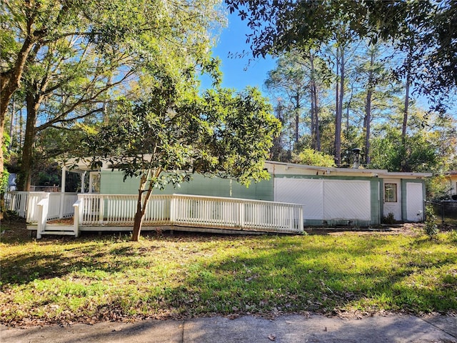 view of property exterior with a yard and a wooden deck