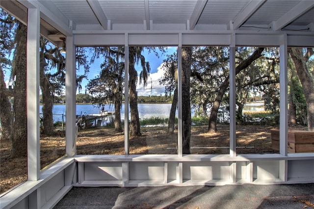 unfurnished sunroom with a water view