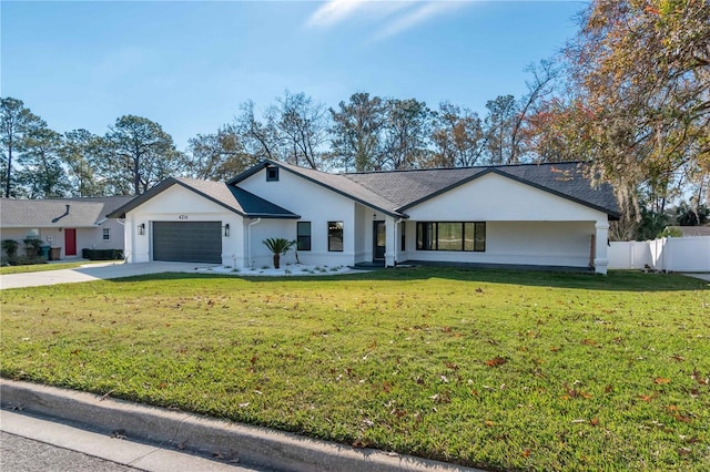 ranch-style house with a garage and a front lawn