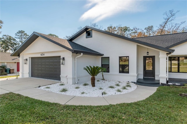 single story home with a garage and a front lawn