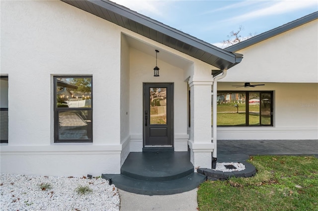 view of exterior entry with ceiling fan