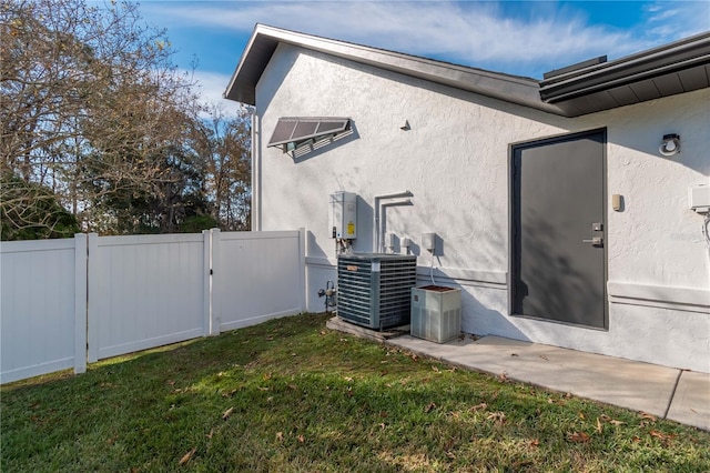 view of property exterior featuring a lawn and central AC unit