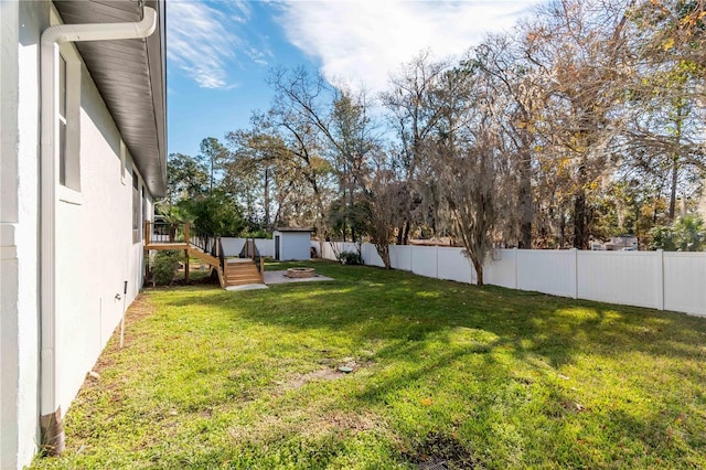 view of yard with a fire pit and a wooden deck