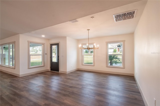 entryway with a notable chandelier, dark hardwood / wood-style floors, and a wealth of natural light