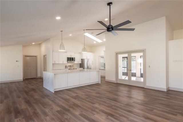 kitchen featuring pendant lighting, white cabinets, ceiling fan, a large island, and stainless steel appliances