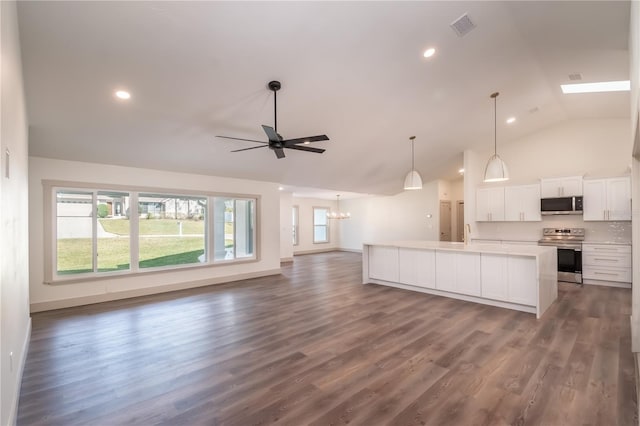 kitchen with a center island, white cabinetry, stainless steel appliances, and dark wood-type flooring