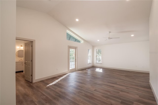 spare room with dark hardwood / wood-style floors, high vaulted ceiling, and ceiling fan