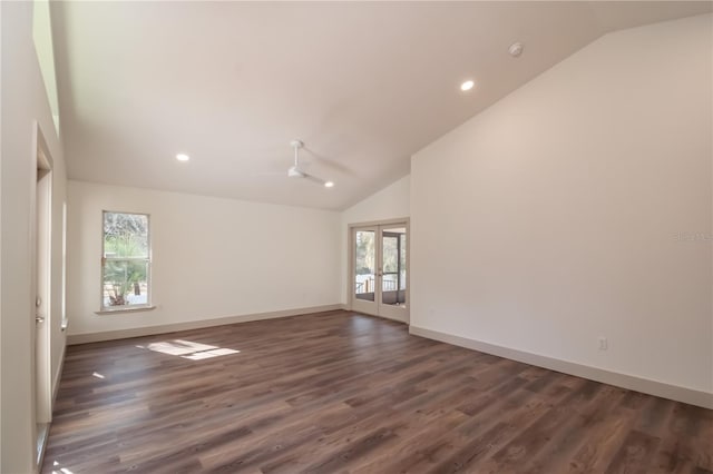 spare room featuring dark hardwood / wood-style flooring, a wealth of natural light, and lofted ceiling