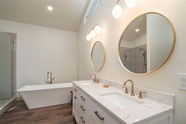 bathroom with hardwood / wood-style floors, shower with separate bathtub, and vaulted ceiling