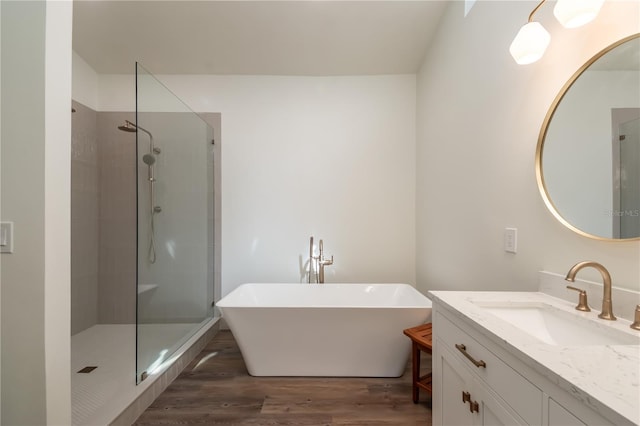 bathroom featuring shower with separate bathtub, vanity, and hardwood / wood-style flooring