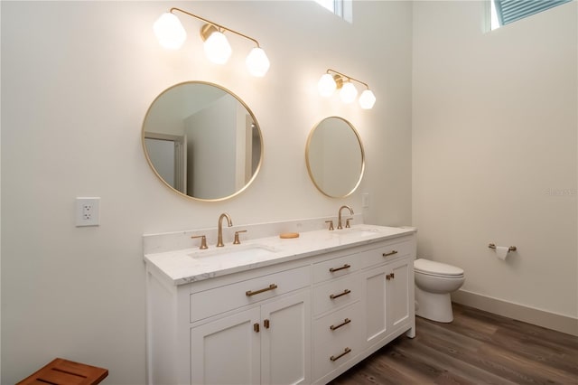 bathroom featuring toilet, vanity, and hardwood / wood-style flooring