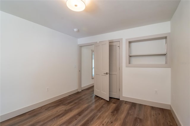 unfurnished bedroom with dark hardwood / wood-style floors