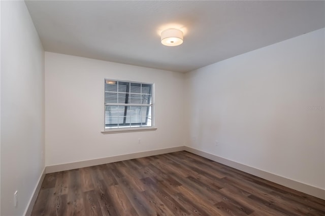 spare room with dark wood-type flooring