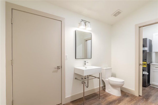 bathroom with hardwood / wood-style flooring and toilet