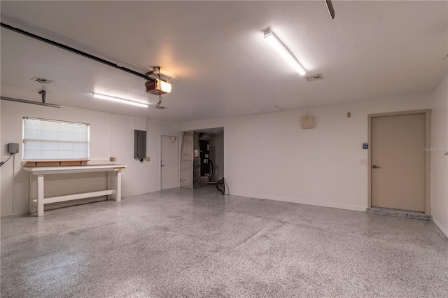 garage featuring electric panel and a garage door opener