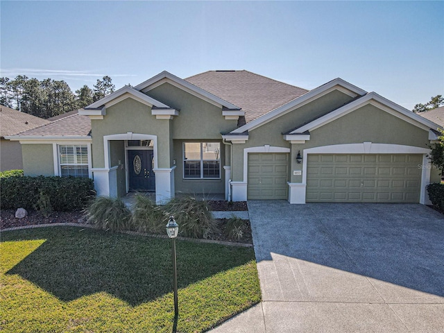 single story home with a garage and a front lawn