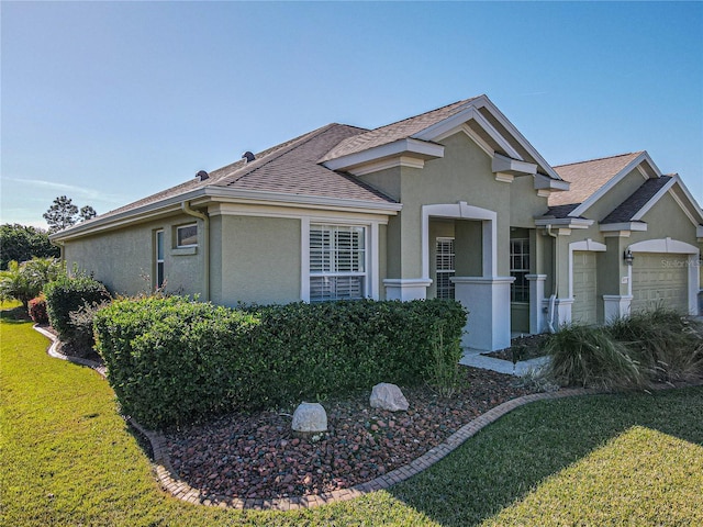 view of front of property with a front yard and a garage