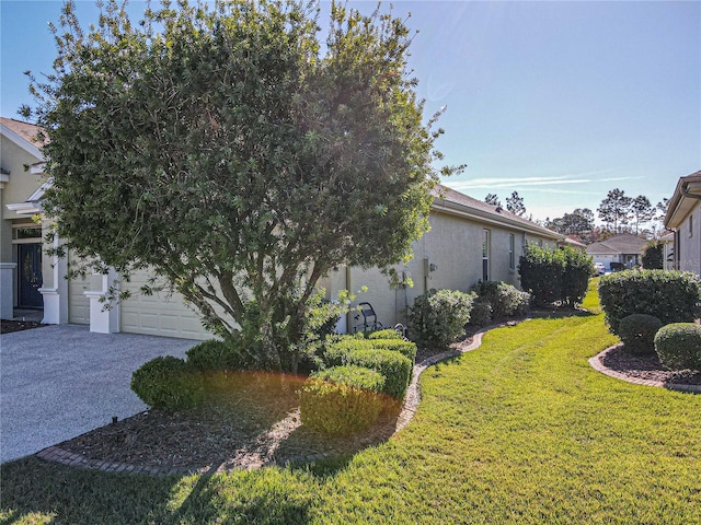 exterior space featuring a lawn and a garage