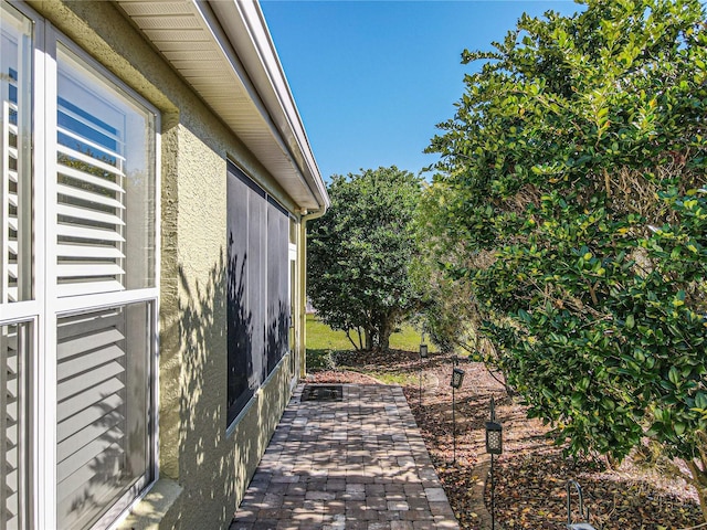 view of side of property featuring a patio