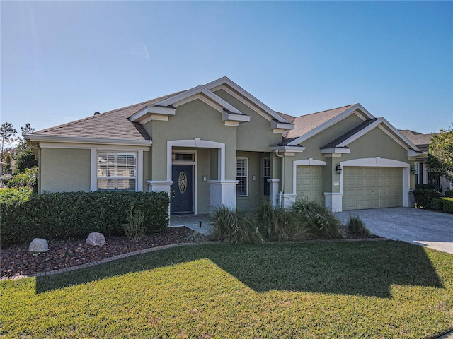 view of front of house with a front yard and a garage