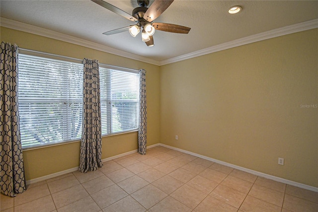 tiled empty room with a textured ceiling, ceiling fan, and ornamental molding