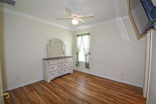 unfurnished bedroom featuring hardwood / wood-style floors, ceiling fan, and ornamental molding