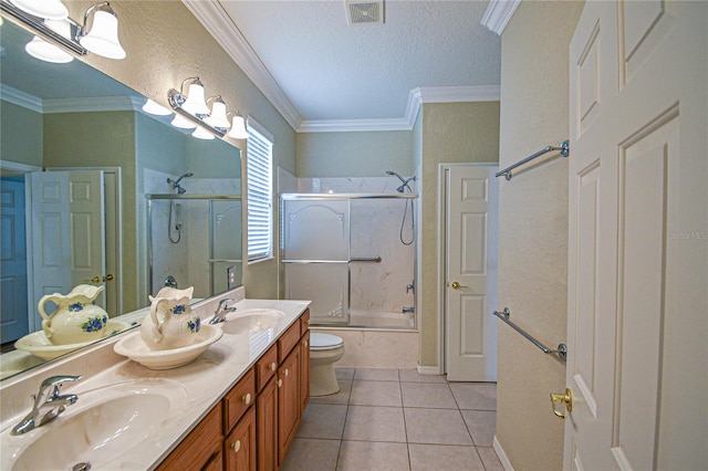 full bathroom featuring toilet, tile patterned floors, crown molding, and bath / shower combo with glass door