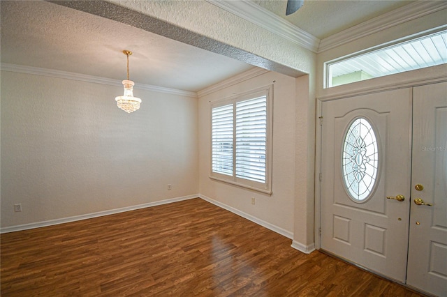 entrance foyer with dark hardwood / wood-style floors and ornamental molding