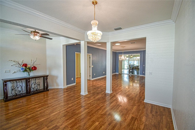 unfurnished dining area featuring dark hardwood / wood-style flooring, ornate columns, and ornamental molding