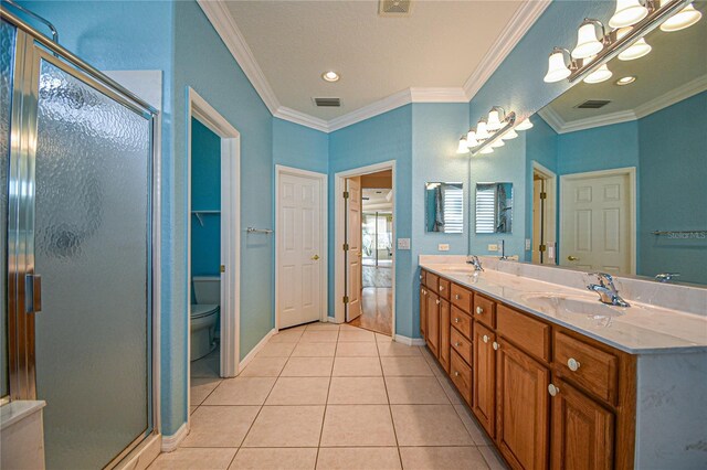 bathroom with vanity, tile patterned floors, a shower with shower door, and crown molding