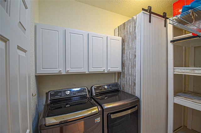 clothes washing area with cabinets and separate washer and dryer