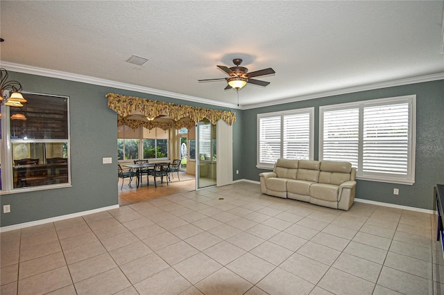 unfurnished living room featuring a healthy amount of sunlight, ceiling fan, crown molding, and light tile patterned flooring