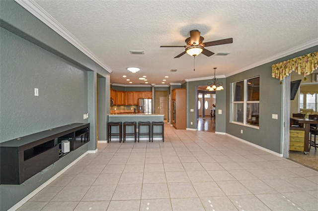 unfurnished living room featuring crown molding, light tile patterned floors, and a textured ceiling