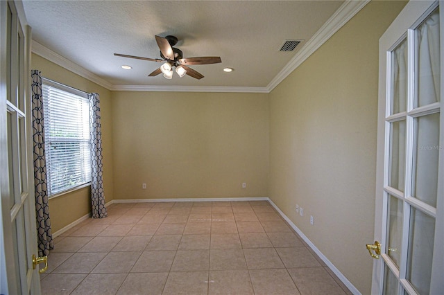 tiled empty room with ceiling fan, a textured ceiling, and ornamental molding