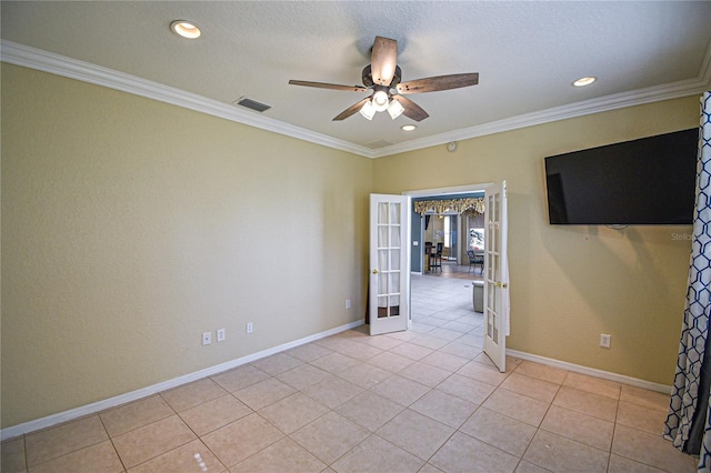 tiled empty room with ceiling fan, ornamental molding, and french doors