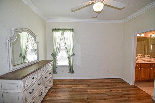 unfurnished bedroom featuring connected bathroom, ornamental molding, multiple windows, and light wood-type flooring