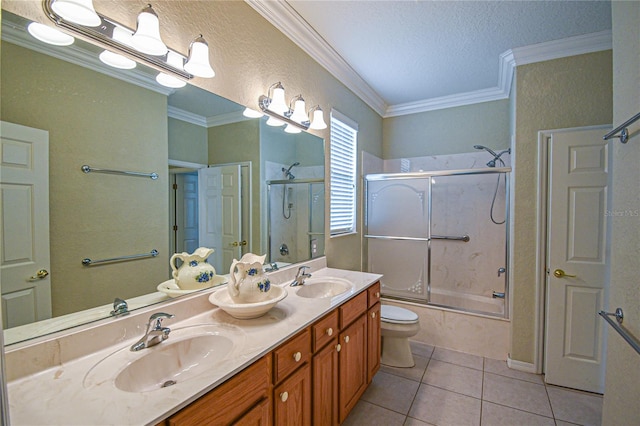 full bathroom featuring tile patterned floors, bath / shower combo with glass door, toilet, vanity, and ornamental molding