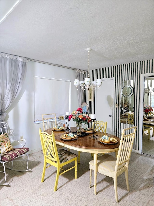 dining area featuring carpet flooring, a textured ceiling, and an inviting chandelier