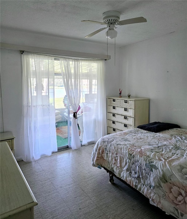 bedroom with access to outside and ceiling fan