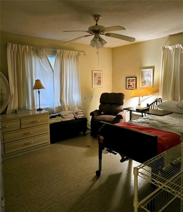 carpeted bedroom featuring ceiling fan and a textured ceiling